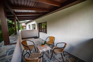 a patio with a table and chairs on a porch at Poiana Cristian in Poiana Brasov