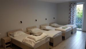 Postel nebo postele na pokoji v ubytování Dom Gościnny Marysieńka