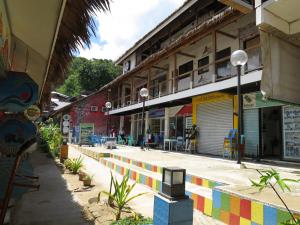 a street with a building with a colorful sidewalk at Dormitels.ph El Nido in El Nido