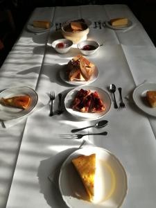 a long table with plates of food on it at B&B Le Grazie in Piaggine