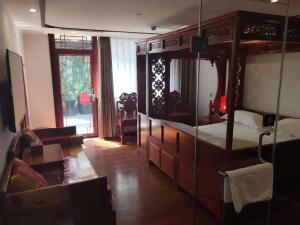Postel nebo postele na pokoji v ubytování Qinfu Hotel Beijing Nanluogu Lane Houhai