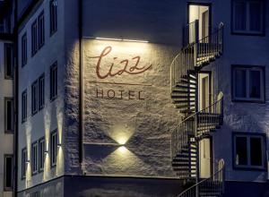 a sign for a hotel on the side of a building at Lizz Hotel Munich in Munich