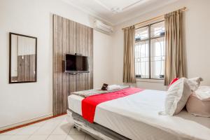 ein Schlafzimmer mit großem Bett und Fernseher in der Unterkunft RedDoorz near UNTAG Surabaya in Surabaya