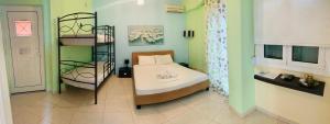 a small room with a bed and a shelf at Schoinaria Bay in Damnoni