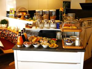 a counter with various dishes of food on it at Hotel Fortuna in Bad Gögging