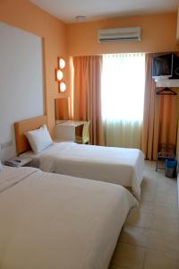 Postel nebo postele na pokoji v ubytování YY38 Hotel
