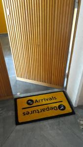a yellow and black sign in front of a door at CameLia in Ivrea