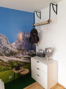 a bedroom with a mountain mural on the wall at Wellnessapartment Alpenland Top 22 in Seefeld in Tirol
