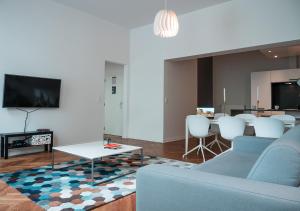 ein Wohnzimmer mit einem Sofa und einem Tisch in der Unterkunft Smartflats - Stephanie in Brüssel