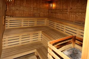 an empty wooden sauna with a bench in it at Hotel SOREA MÁJ in Liptovský Ján