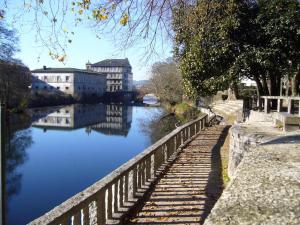 a bridge over a river with buildings in the background at Casa Marina in Caldas de Reis