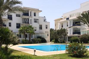 an apartment with a swimming pool and two buildings at Résidence Beach Mogador, Appartement n°29 in Essaouira