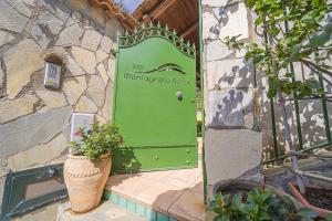 a green door with a plant in front of it at Montagnella Relax in Maiori