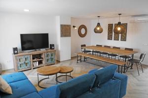 a living room with a blue couch and a table at Modern house in Calle Carretas in Nerja