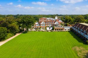 a large green field with a house and some trees at Chewton Glen Hotel in New Milton