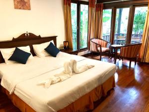 a bedroom with a large bed with white sheets at Phangan Paragon Resort & Spa by Pure Lifestyle in Haad Chao Phao +68 photos
