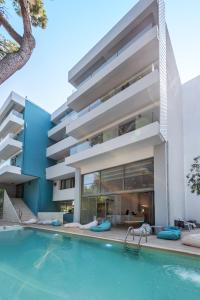 an exterior view of a building with a swimming pool at Triton Boutique Hotel in Kos Town