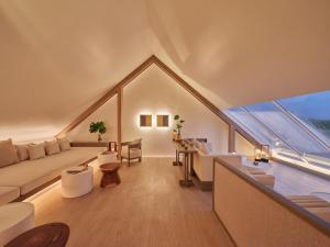 a large living room with a large window and a couch at Sala Ayutthaya in Phra Nakhon Si Ayutthaya