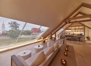 a living room with white furniture and large windows at Sala Ayutthaya in Phra Nakhon Si Ayutthaya