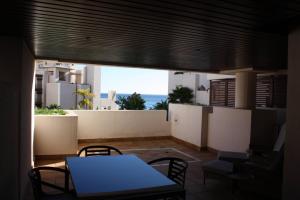 a table and chairs on a balcony with a view of the ocean at 107 - Two-Bedroom Beach Apartment in Estepona