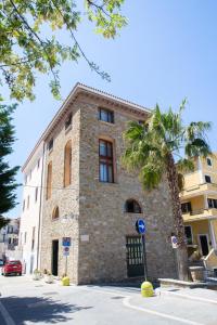 
a large brick building with a clock on the side of it at Casa Trezeni in Santa Maria di Castellabate
