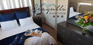 a room with two beds and a guest house at Seagulls Guest House in Langebaan