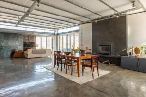 a large living room with a table and chairs at Sunset-Loft in Cape Town