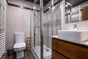 a bathroom with a toilet and a sink and a shower at ARTIGA de Alma de Nieve in Baqueira-Beret +2 photos