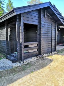 a brown building with a large garage at Arcticson / pohjosen poika in Syöte