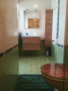 a bathroom with a sink and a mirror at Apartma Zalka in Izola +27 photos
