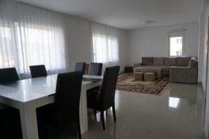 a living room with a table and chairs and a couch at Villa ‘Stone Chair’ in Sarajevo, Vogosca in Vogošća