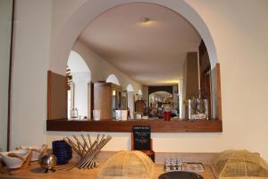 an archway in a room with a table with a mirror at Bergerie du Château - Lacapelle Marival in Lacapelle-Marival