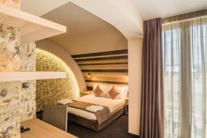 a hotel room with a bed and a window at Budapest Hotel in Sofia