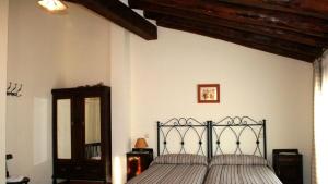 sypialnia z łóżkiem z czarną ramą i lustrem w obiekcie Las casas de Yagüe, Ayllón w mieście Santa María de Riaza
