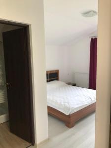 a bedroom with a bed and a door open at Casa EVA in Panaci +4 photos