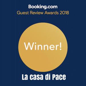 a yellow circle with the words guest review awards at La casa di Pace in Messina