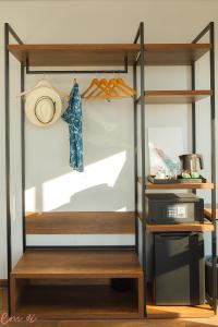 a room with a shelf with a hat and a pot at Em Oi Boutique Hotel in Nha Trang