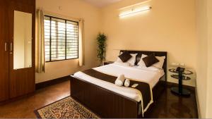 Lova arba lovos apgyvendinimo įstaigoje Nandu Hospitality - Aashiyana