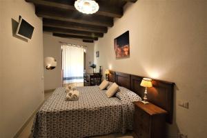 a bedroom with a white bed and white walls at L'Antica Torre in Cagliari