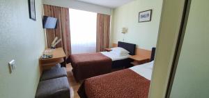 Postel nebo postele na pokoji v ubytování Toila Spa Hotel