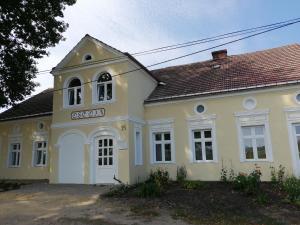 a large yellow building with a sign on it at Dom Gościnny Ostoja in Międzywodzie