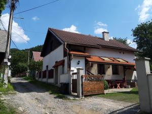 a white house with a brown roof at Čavoj Guest House in Čavoj