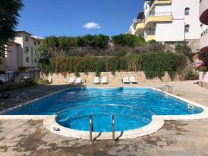 a swimming pool in the middle of a building at Femili Hotel Diveda in Sveti Vlas