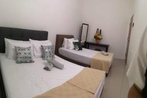 a bedroom with two beds and a table at 3133 Heritage Home in George Town