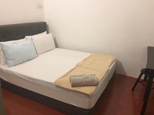 a bed with white sheets and a bag on it at 3133 Heritage Home in George Town
