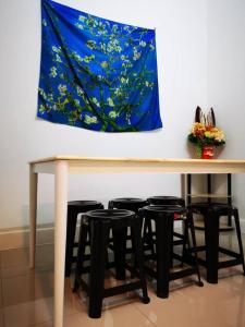 a table with four stools under it with a painting at 3133 Heritage Home in George Town