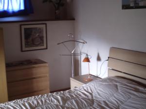 a bedroom with a bed and a lamp on a dresser at B&B Casa Villa Siviglia in Marliana