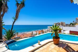 a swimming pool with a view of the ocean at Stunning Beachclose Villa by Costarentals - Ref 03 in Fuengirola