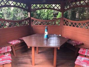a table in a cabin with a lighthouse on it at Villa Papaj in Międzyzdroje