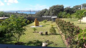 a garden with a large yellow sculpture in the grass at Ossanzaia Bilene Lodge in Vila Praia Do Bilene